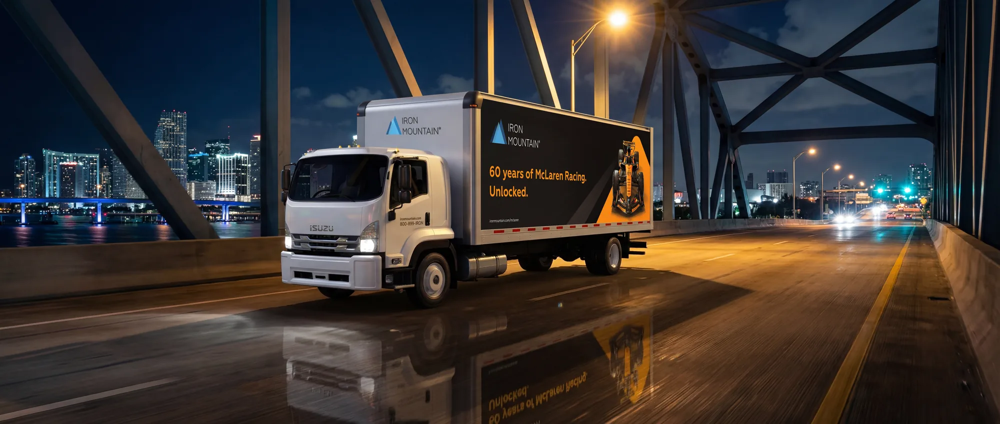 Iron Mountain McLaren truck crossing a Miami causeway bridge at night