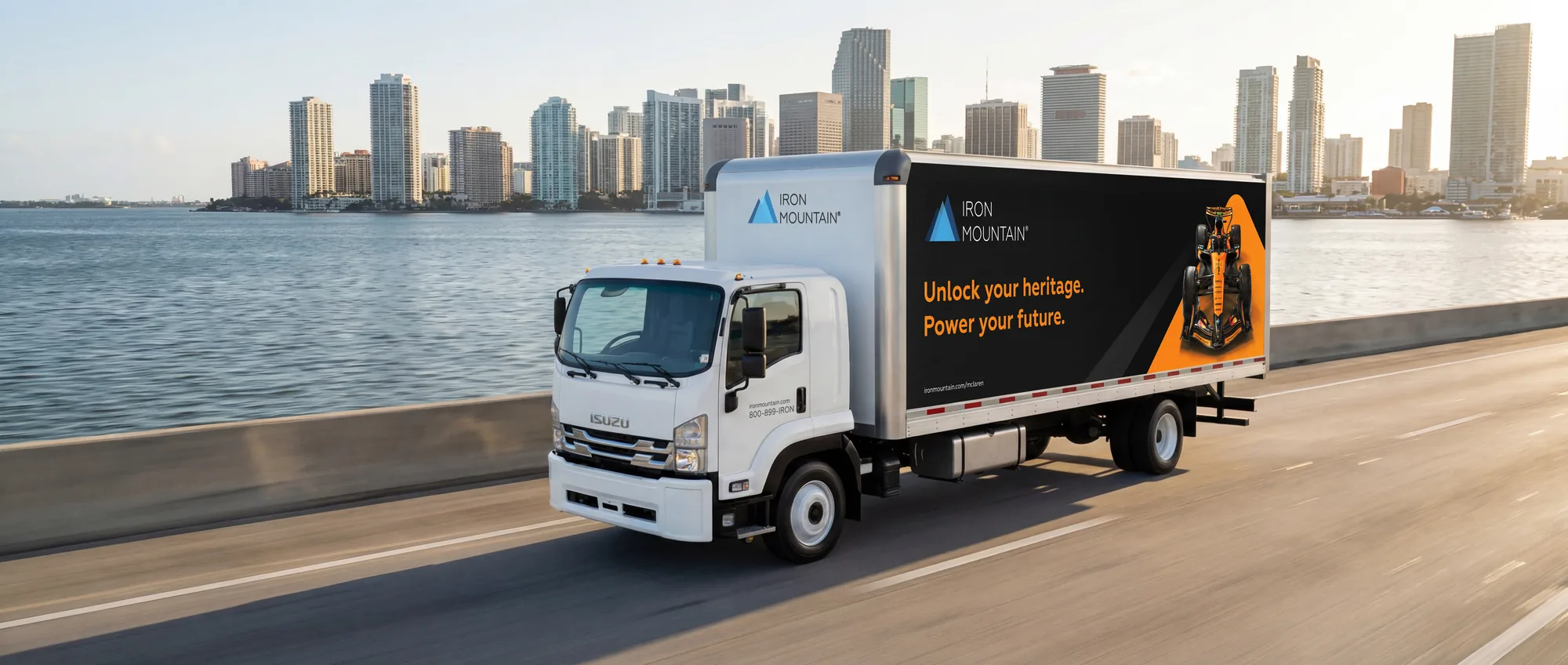 Iron Mountain McLaren truck on a Biscayne Bay causeway at dusk