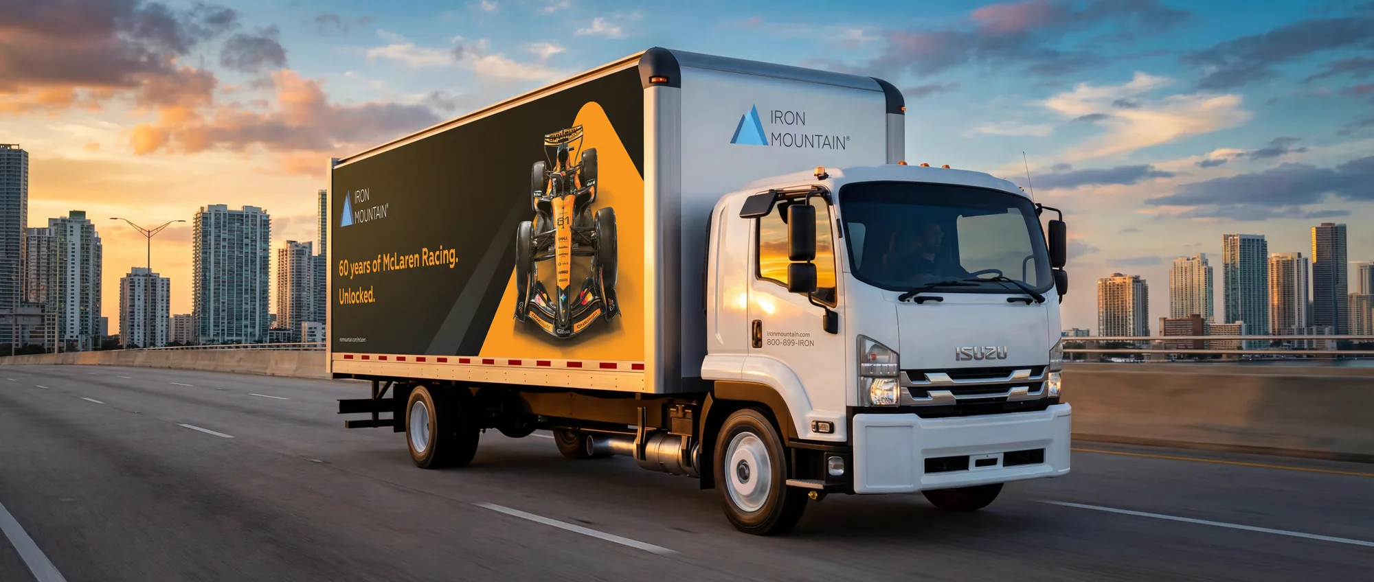 Iron Mountain McLaren Racing box truck rendered on a Miami causeway at sunset