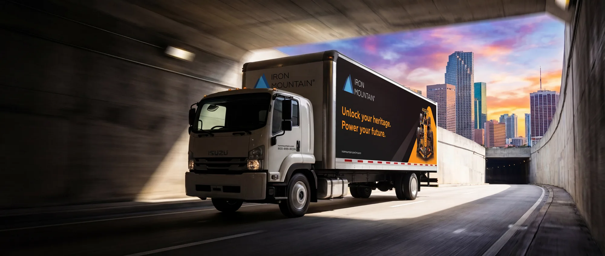 Iron Mountain McLaren truck emerging from a downtown underpass at sunset